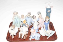 Collection of ten Lladro figures including clown with puppy, rocking chair, and Spanish girl.