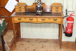 Late 19th/early 20th Century oak six drawer writing table on turned reeded legs, 107 by 51cm.