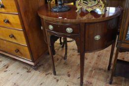 19th Century mahogany demi-lune side cabinet having frieze drawer flanked by cupboards raised on