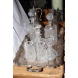 Silver plated tea tray, two EP mounted claret jugs, four crystal decanters,