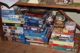 Large collection of over sixty jigsaw puzzles.