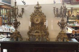 Highly ornate brass clock set, candelabra 67cm high.