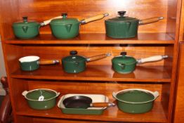 Ten pieces of green Le Creuset Invicta ware.