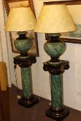 Pair of green pottery table lamps on stands, height of stand 83cm, lamp height 80cm.