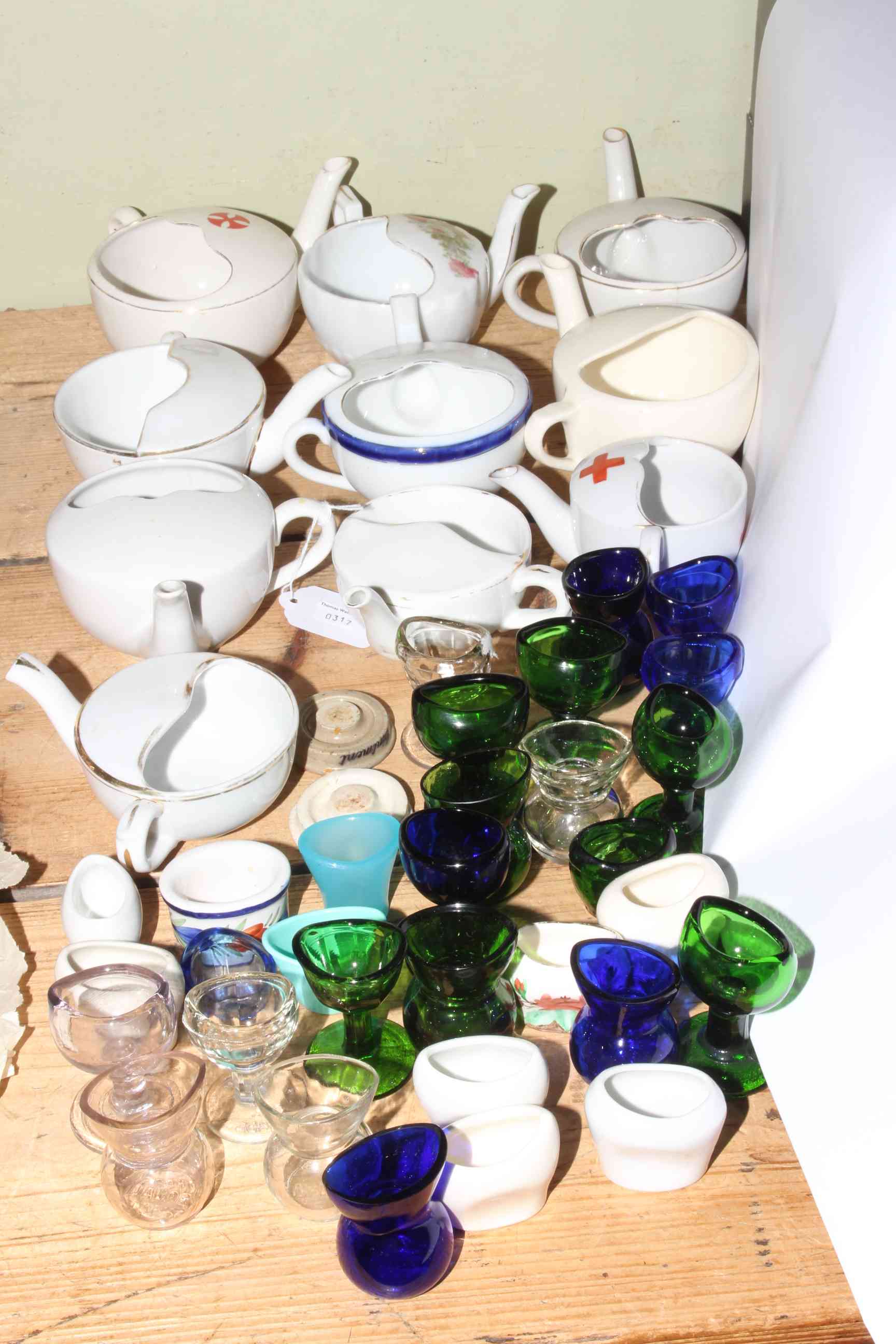 Ten vintage feeding cups and over thirty eye baths.