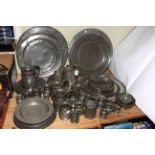 Large collection of antique pewter comprising five chargers, seventeen plates, warmer,