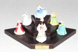 Seven Royal Doulton miniature ladies on stand.