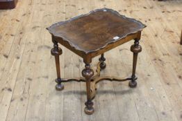 Walnut shaped top lamp table raised on turned legs to shaped stretchers,