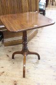 Mahogany square top snap top table raised on turned column to triform base.