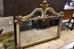 Ornate gilt and white painted framed wall mirror, 128cm by 105cm.