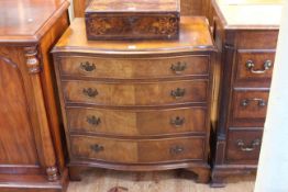 Walnut serpentine front chest of four long graduated drawers on shaped bracket feet,