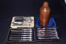 Two cased sets of silver handled tea knives, twelve silver pistol grip knives,