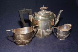 Three piece silver part fluted tea set, teapot Chester 1906, sugar and cream, Sheffield 1905.