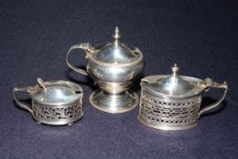 Collection of three silver lidded mustard pots including two pierced oval, all with liners, Chester,