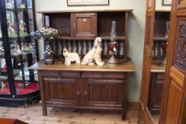 Art & Crafts oak sideboard in the manner of Liberty's the raised back having cupboard door above a