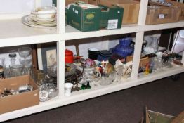 Full shelf of china, glass, metalware, cutlery, twin branch brass oil lamp,