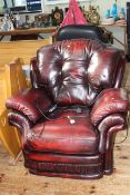 Thomas Lloyd ox blood leather electric reclining armchair.
