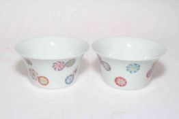 Pair Chinese tea bowls with 'floating roundels' decoration.