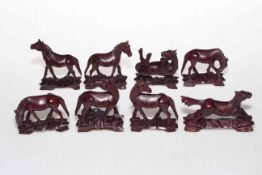 Set of eight Chinese carved wood Mu Wang horses with glass eyes, 7cm.