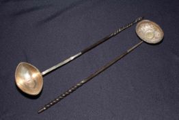 Two Georgian silver tody ladles, both inset with coins.