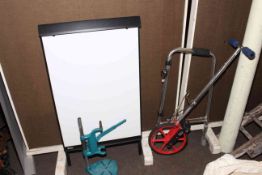 Bench drill stand by Black & Decker, Zenith Surveyor's measuring wheel, Sasco flipchart, easel, etc.