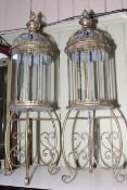 Pair of gilt metal and glazed hall lanterns on ornate stands, 109cm high.