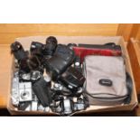 Box of cameras and lenses.