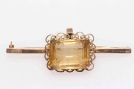 14 carat bar brooch with large emerald cut stone.