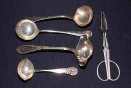 Four different silver sauce ladles, two with ornate handles, and pair of tongs stamped 100 (5).