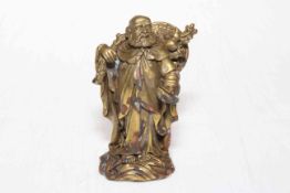 Chinese gilt bronze figure of travelling elder, 9.5cm.
