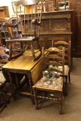 Carved oak court cupboard, oak gate leg dining table and five ladder back dining chairs.