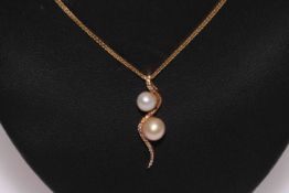 9 carat gold two pearl pendant and chain necklace.