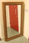 Rectangular gilt framed bevelled wall mirror, 142cm by 80cm overall.