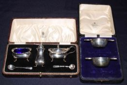 Cased silver three piece cruet, Birmingham 1929, and cased 'quaich' shaped open salts.