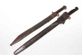 Two bayonets and scabbards, both blades by Wilkinson, one dated 1907.