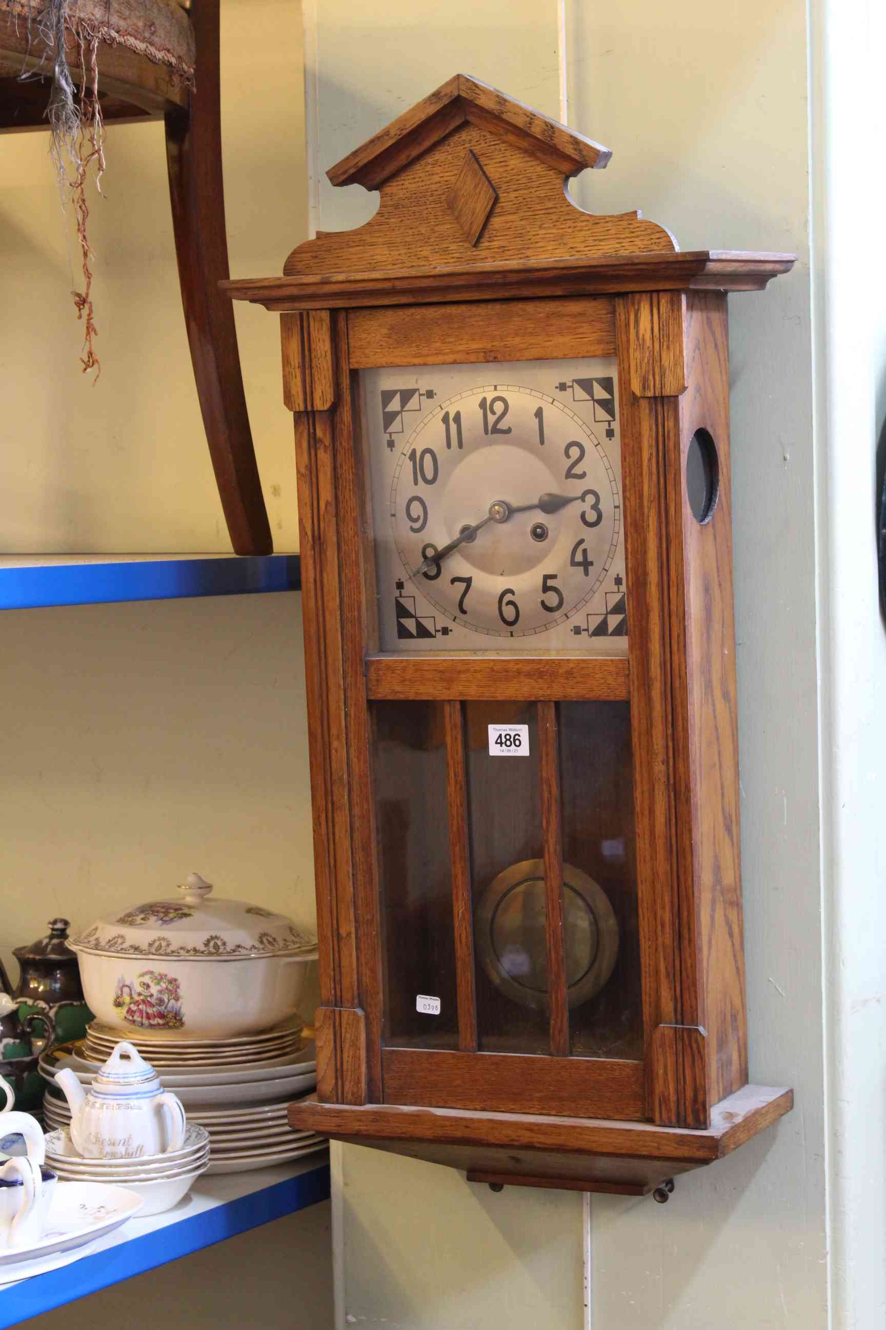 1920's/30's oak wall clock having silvered dial.