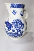 Late 18th Century blue and white cabbage leaf jug with mask spout, 20cm.