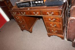 Mahogany nine drawer pedestal desk, 77cm by 122cm by 61cm.