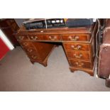 Mahogany nine drawer pedestal desk, 77cm by 122cm by 61cm.