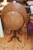 Two antique oak circular snap top tripod tables.