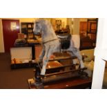 Thoroughbred Horses rocking horse on safety stand, 111cm by 121cm.
