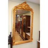 Good gilt framed rectangular bevelled wall mirror with ornate crest, 155cm by 84cm overall.