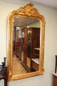 Good gilt framed rectangular bevelled wall mirror with ornate crest, 155cm by 84cm overall.