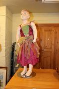 Dressed child mannequin on stand.