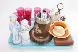 Nine Cranberry glasses, four bottle cruet, pair Continental figures, Clarice Cliff cup and saucer,