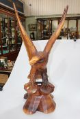 Carved wooden sculpture of an eagle with splayed wings, 92cm high.