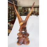 Carved wooden sculpture of an eagle with splayed wings, 92cm high.