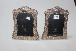 Pair of boxed embossed silver easel photograph frames.