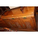 Late Victorian carved oak three door sideboard, 92cm by 134cm by 48cm.