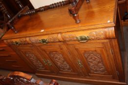 Late Victorian carved oak three door sideboard, 92cm by 134cm by 48cm.